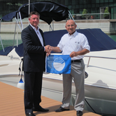 Paul-Sorrell--Marina-Manager-for-Al-Bandar-Marina-receives-Blue-Flag-from-Moaz-Sawaf-from-EWS-WWF.png